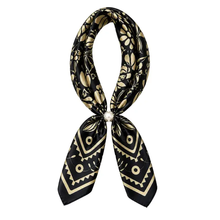 Black scarf necklace with cream floral and geometric print and a pearl magnetic closure, displayed against a white background.
