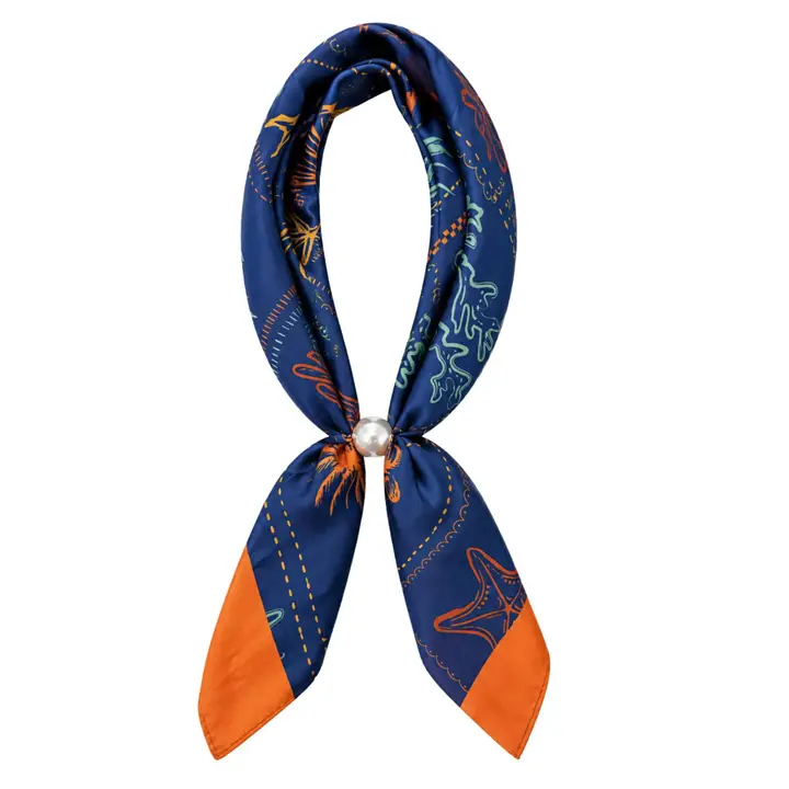 Navy printed scarf necklace with colorful accents, orange tips, and a pearl-detail closure