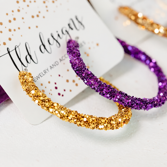 Purple and gold hoop earrings with sparkling textured finish