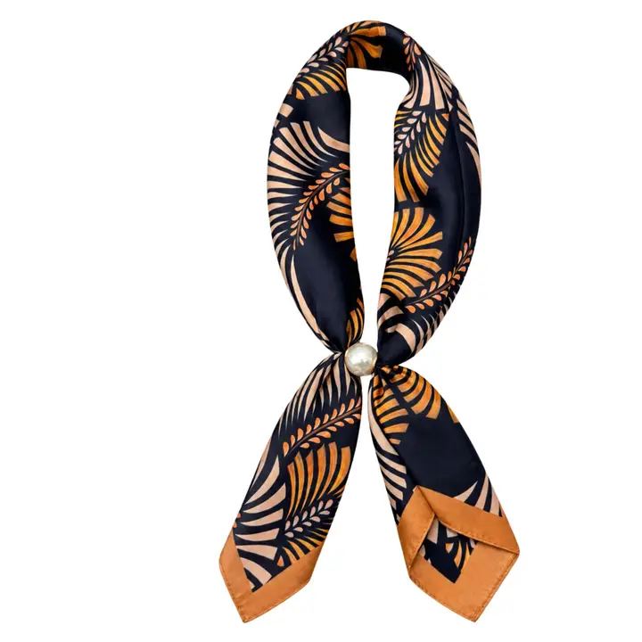 Black scarf necklace with tan and orange fan-inspired print and a pearl center closure, shown against a white background.