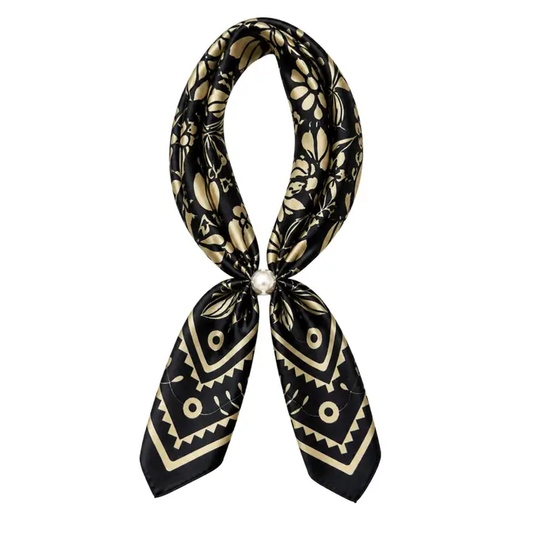 Black scarf necklace with cream floral and geometric print and a pearl magnetic closure, displayed against a white background.