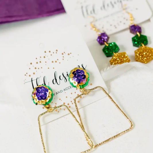 Mardi Party earrings with purple, green, and gold sparkling stud accents and open gold-tone geometric drops